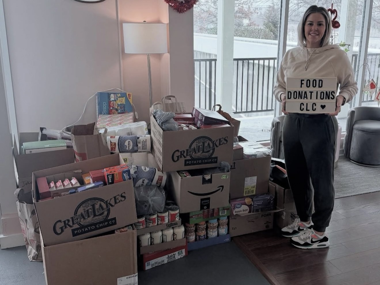 Noga posing with boxes of items to be donated
