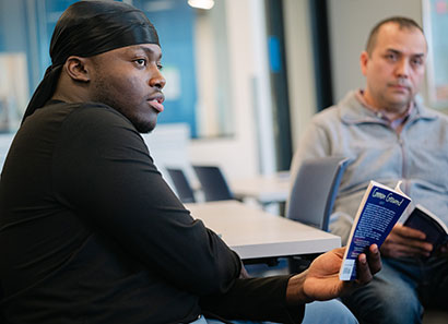 Two adult students participating in class discussion