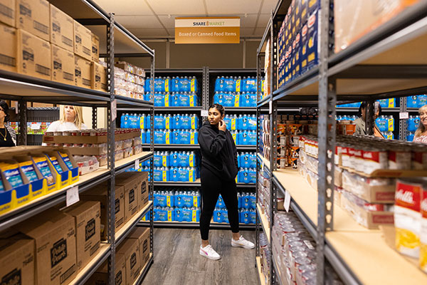 A female student walks the aisle of the Share Market