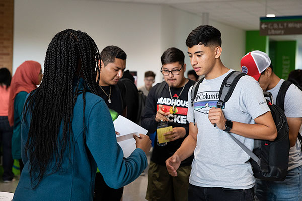Students asking a college rep questions
