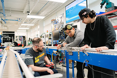 Students troubleshooting an automation line
