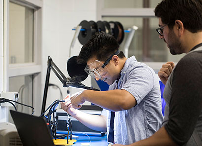 Student soldering in Baxter Innovation Lab