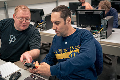 Adult students working together in class.
