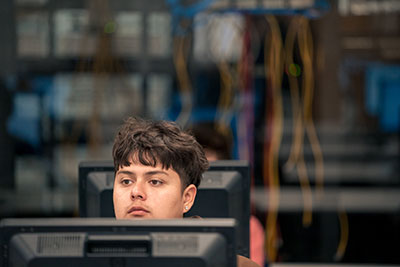 Student in class with lab in background