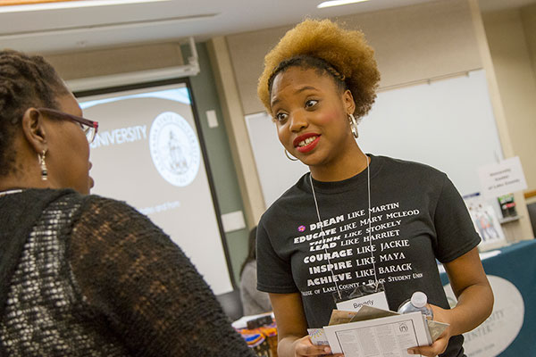 Student talking to a representative about college options.
