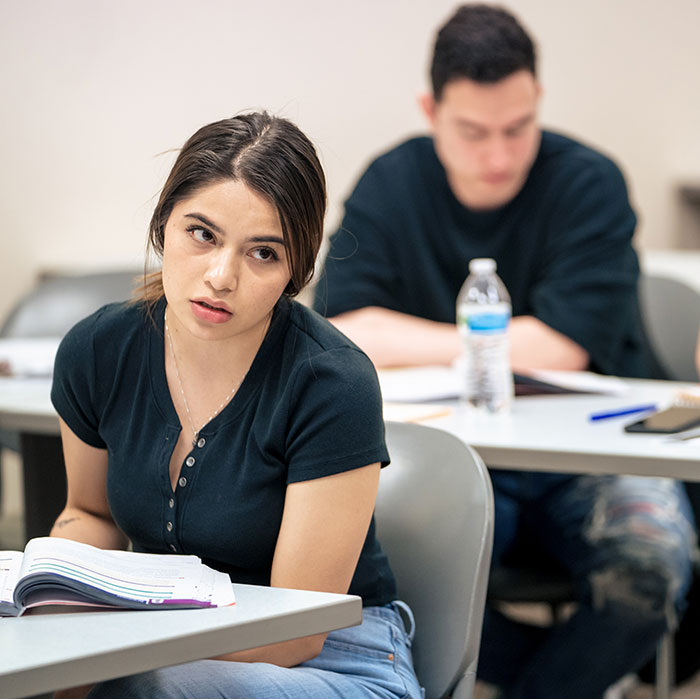 Female student listening intently in class.