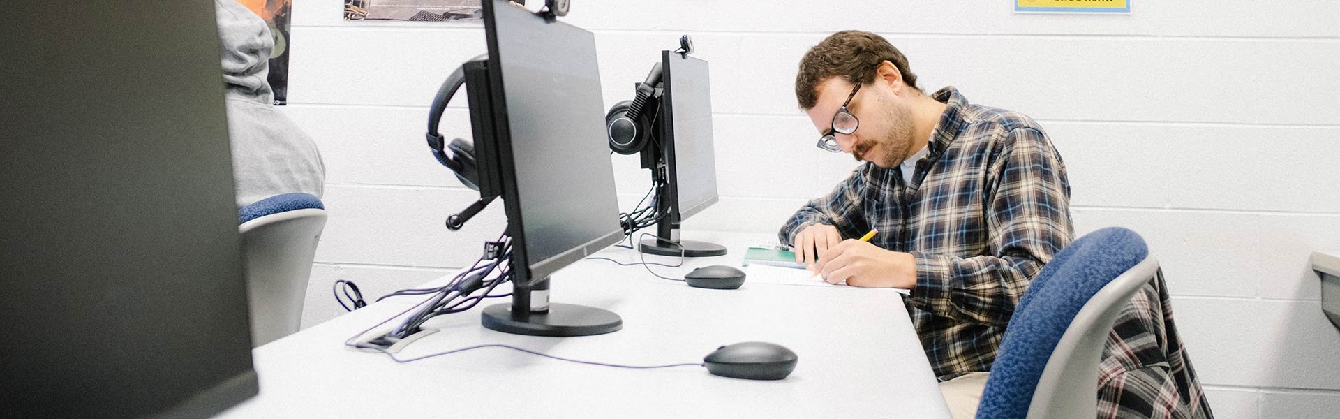 Student sits at desk writing