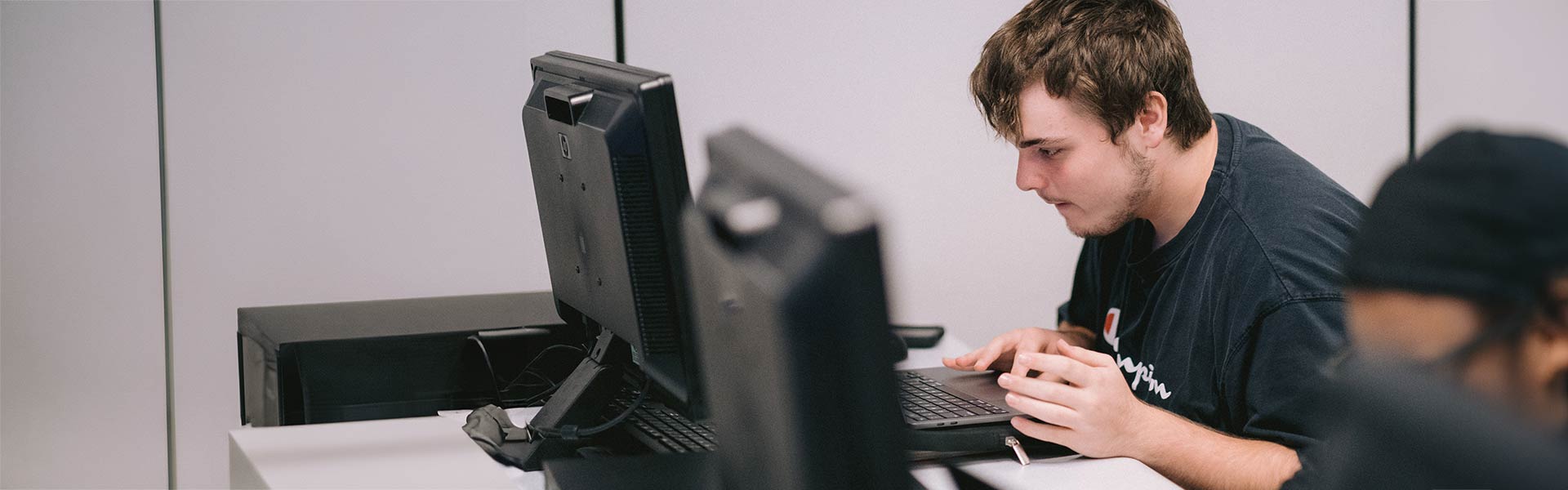 Student sits at computer working