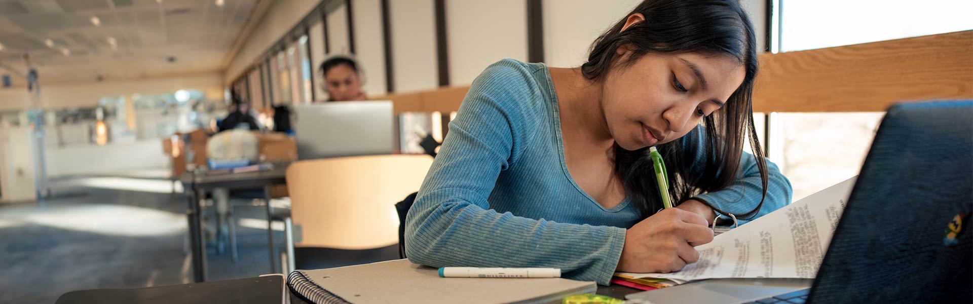 Student sits at desk studying