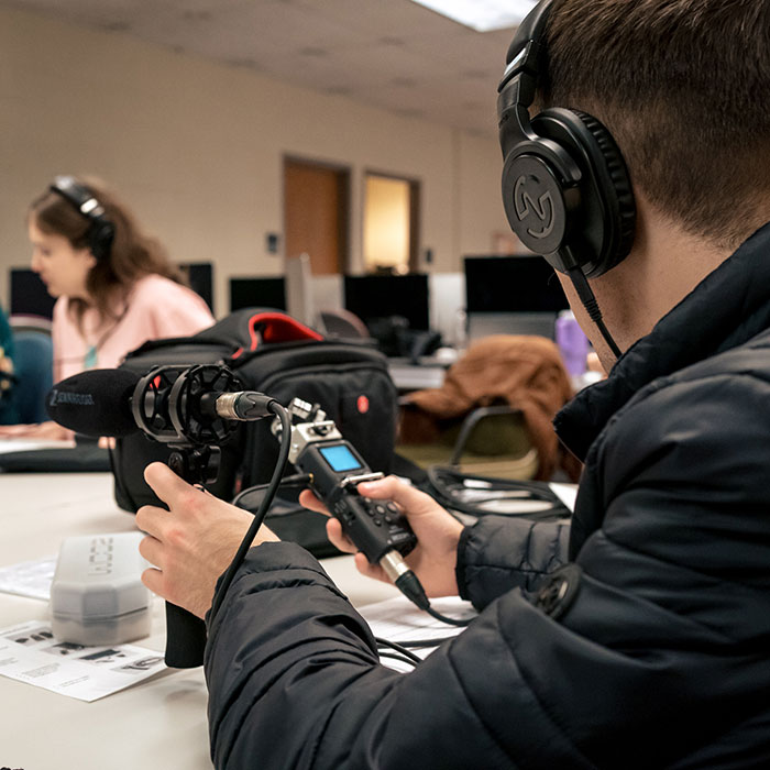 A student learns about equipment in a Digital Media and Design class.