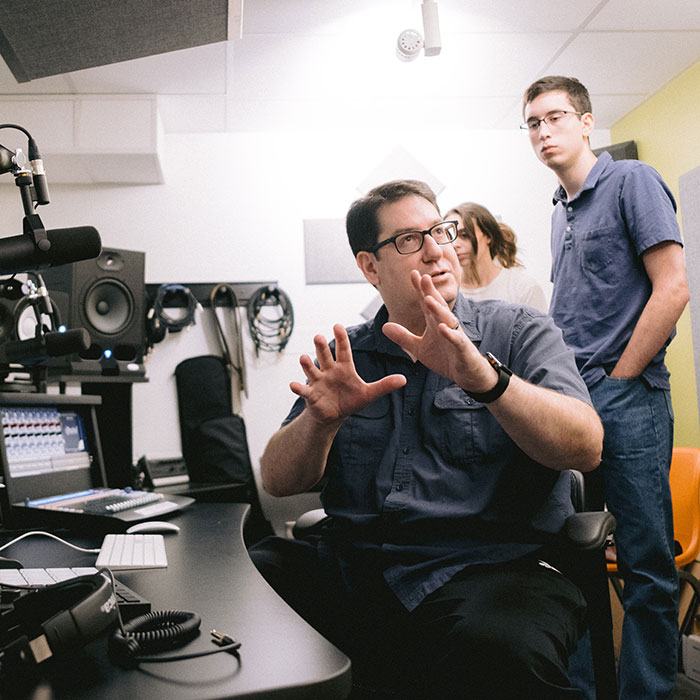 An instructor teaches students in the lab about digital sound.
