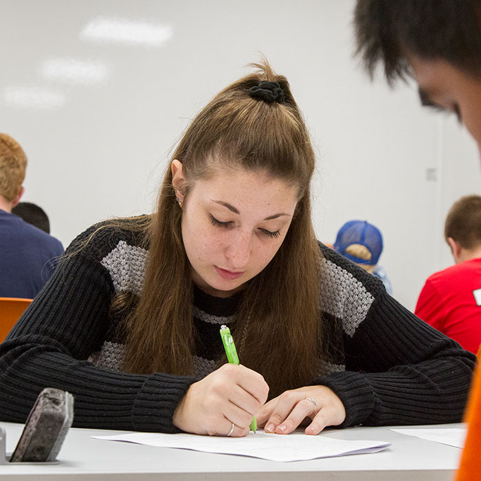 Female student studying in class.
