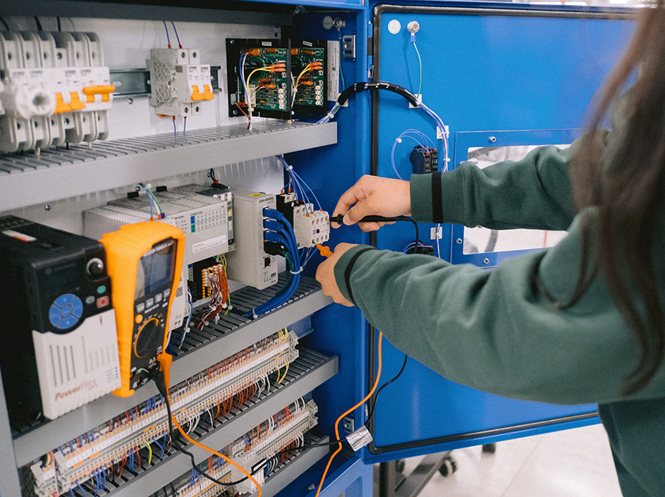Student working with electrical components in the Industrial Technology Lab.