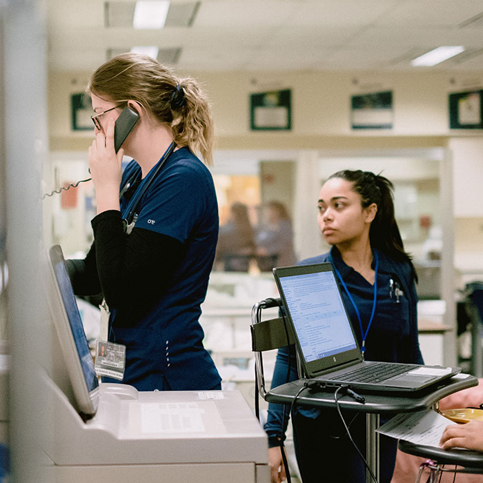 Two students training in hospital setting