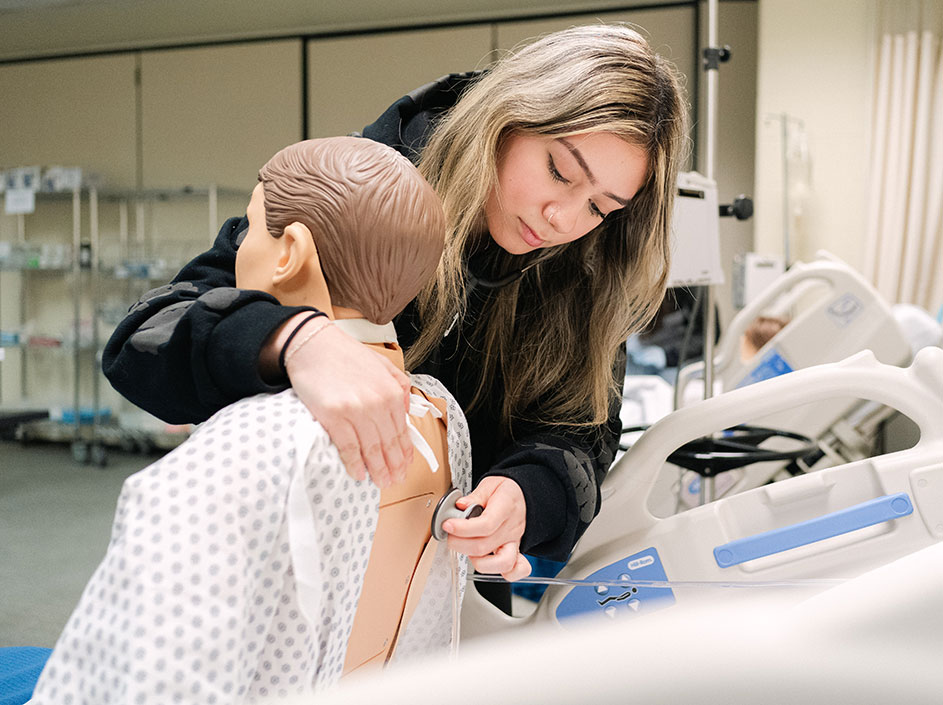 Nursing student practicing skills in simulation lab