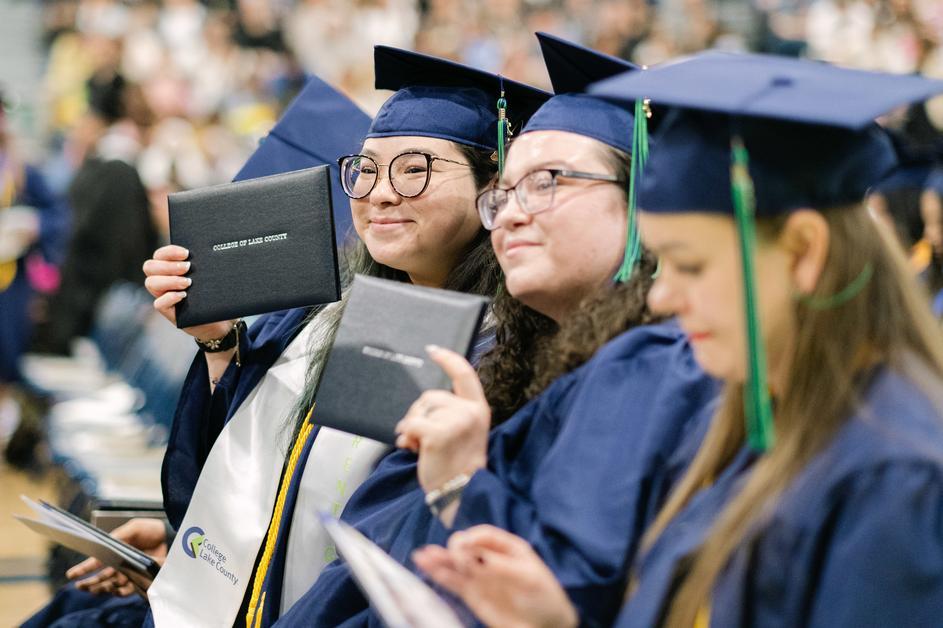 Graduates smiling with their diplomas