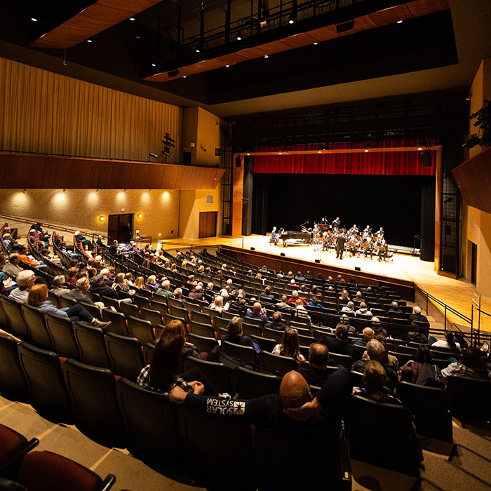 Audience enjoying musical performance in the James Lumber Center