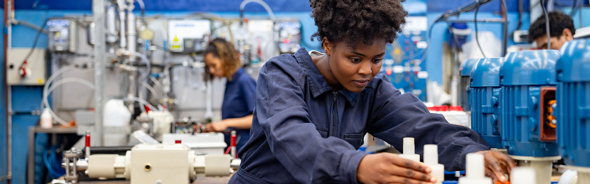 Photo of an employee working at a modern manufacturing facility