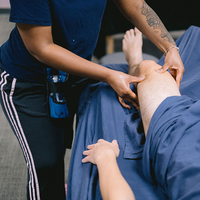 Student performing therapeutic massage on patient at Southlake Campus clinic