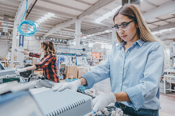 Two women working on a light manufacturing line
