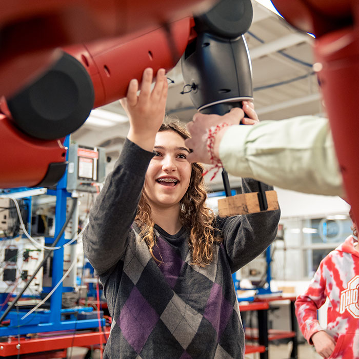 Future student exploring robotics at open house event