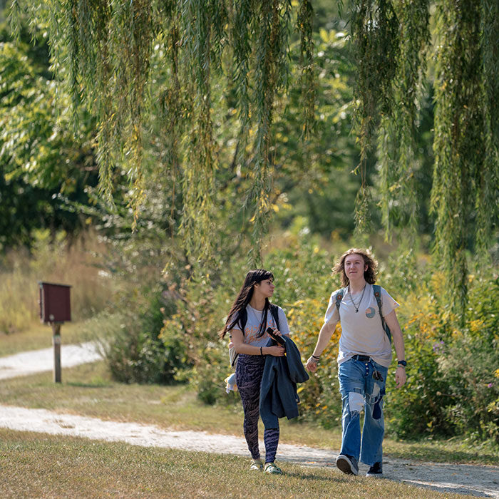 Two students walking along the Living Lab Trail.
