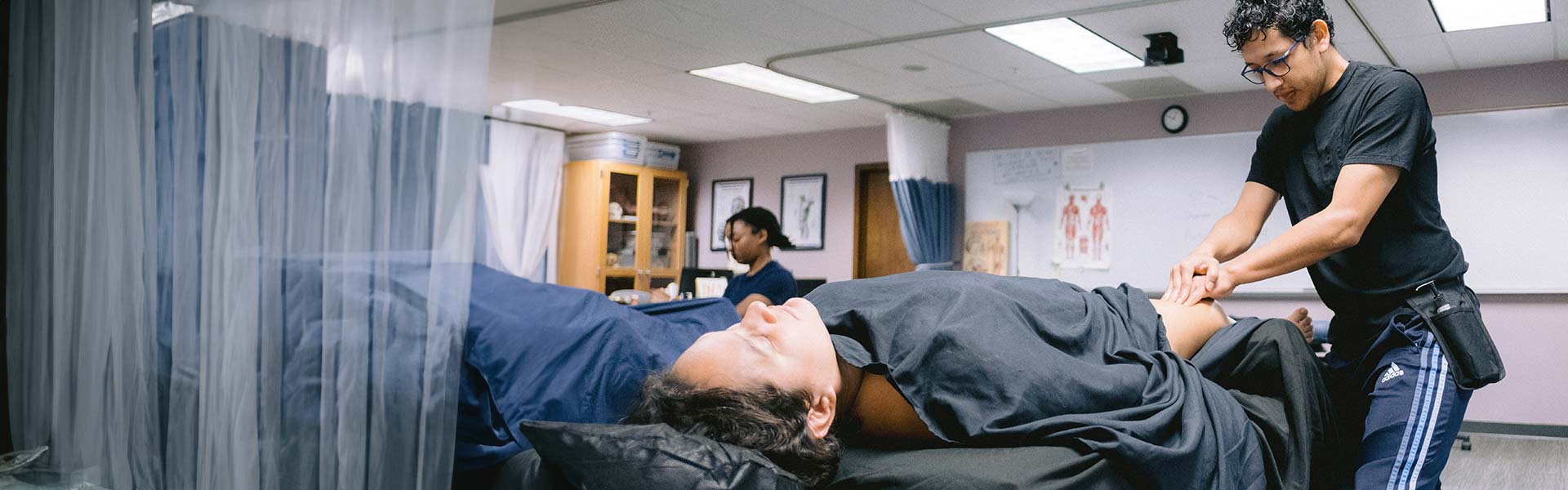 Student massage therapist giving a massage