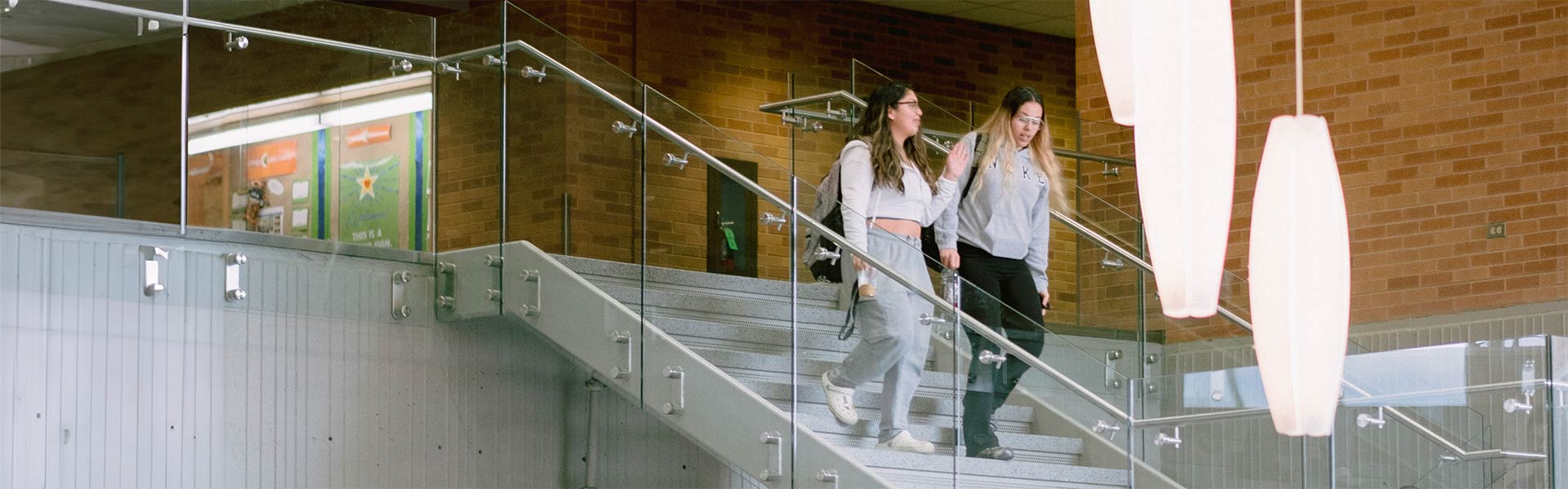 Two students walk down the stairs