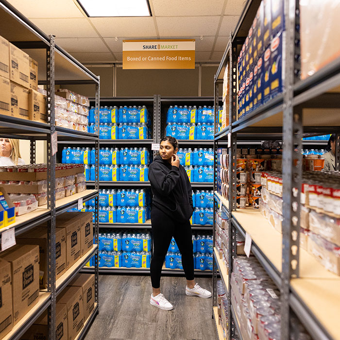 Student walking through aisles of SHARE Market