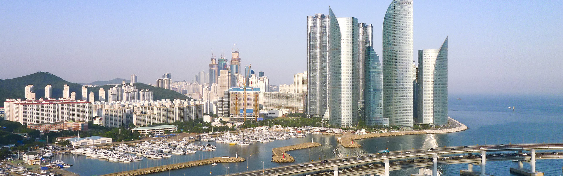 Big cityscape of South Korean city on the water.