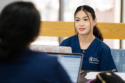 Female nursing student talking to classmate
