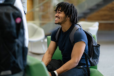 Male student engaging with friends