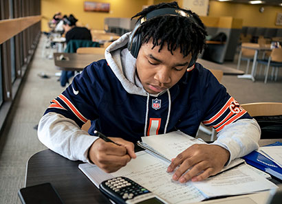Student with head phones studying