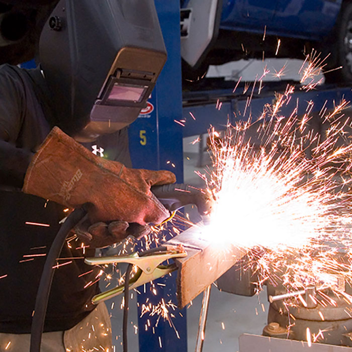 Close up of welder at work with sparks flying