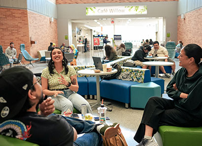 A group of CLC students laughing and talking to each other at the Willow Cafe