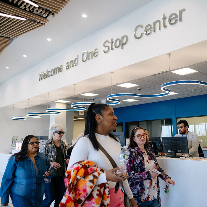 Students and community members walking by the Welcome and One Stop Center at Lakeshore Campus