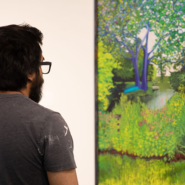 Man studying a painting at Robert T. Wright Community Gallery of Art