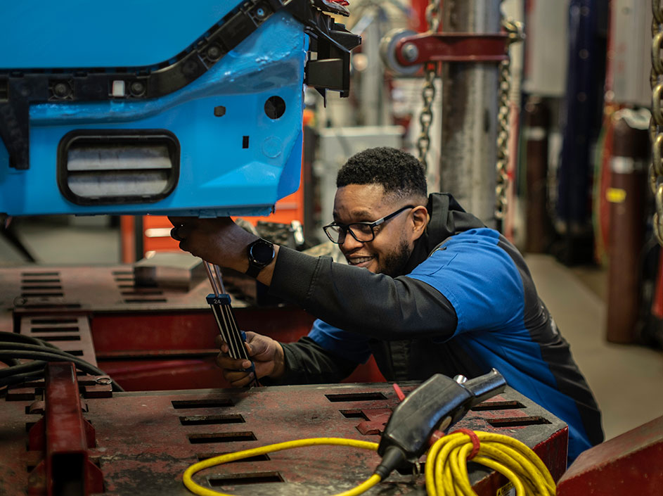 Student learning to repair a car